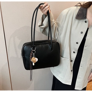 Détail du sac à épaule en cuir PU noir avec pendentif sur le thème du baseball