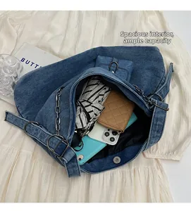 Interior view showing large capacity and magnetic closure of the blue denim tote bag