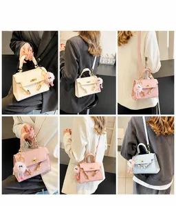Detail view of embossed leather crossbody bags in white and pink with plush charms