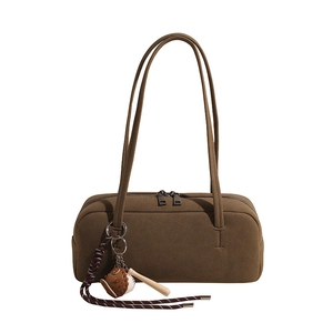 Minimalist dark brown suede tote bag featuring a sporty baseball glove charm pendant