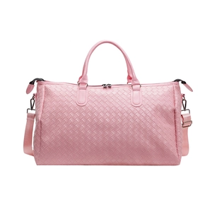 Detailed view of the pink Intrecciato woven texture on a large travel duffel bag for women