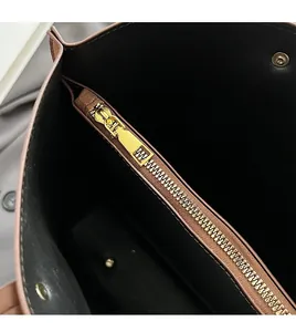 Detail of premium golden metal zipper and snap button on casual large tote bag interior