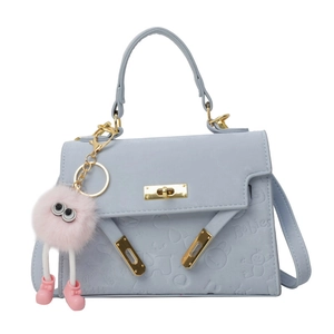 Light blue textured handbag with Babies embossing and a pink monster plush keychain