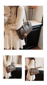 Detailed view of deep brown vintage shoulder bag with soft plush dice charm accessory
