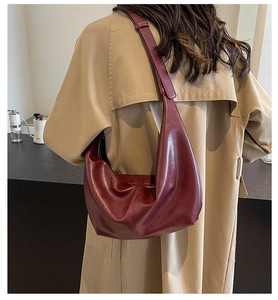 Hobo shoulder bag in deep burgundy PU leather shown on model's shoulder in lifestyle setting
