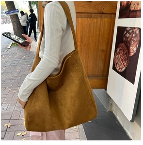 Detail shot of large brown suede tote bag with spacious interior for daily commute