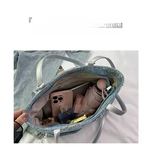 Top view of large capacity blue sequin tote bag with silver handles and interior storage
