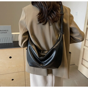 Model view showing black crescent moon PU leather tote bag with adjustable strap