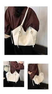 Detail of cream white PU leather tote bag showing adjustable straps and textured finish