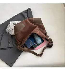 Close-up of brown suede tote bag interior showing ample space for tablets and umbrellas