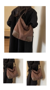 Detail of suede tote bag showing reinforced corners with white stitching and leather texture