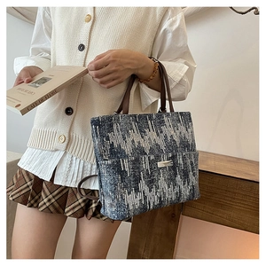 Detail of glitter geometric pattern shoulder bag with brown leather straps and metal logo