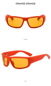Close-up of bright orange Y2K futuristic wrap sunglasses with thick frames from side view