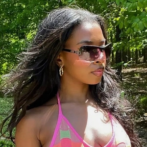 Y2K rimless wrap sunglasses on model in outdoor forest setting with retro aesthetic