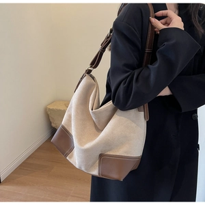 Canvas and caramel leather patchwork tote bag shown on model for daily commuting