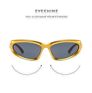 Detailed view of wrap-around futuristic Y2K sunglasses with golden frames and grey lenses