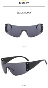 Detail view of black shield sunglasses with silver star rivets on wide temples