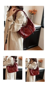 Detail of burgundy patent leather tote bag featuring elegant bow tie decor and glossy texture