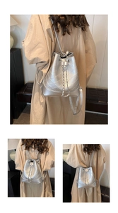 Detail of silver quilted bucket bag with chain drawstring and metallic finish