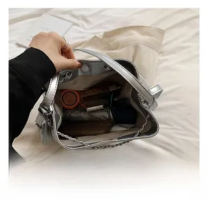 Interior view of silver bucket bag with chain strap showing spacious storage capacity