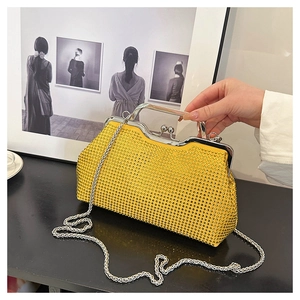 Detail of yellow rhinestone evening bag with silver ring handle and delicate chain strap