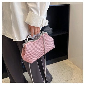 Detail of pink rhinestone evening bag with silver metal frame and detachable chain strap