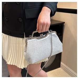 Model showing white rhinestone shell bag with metal chain strap and vintage clasp