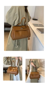 Detail of caramel lychee grain leather handbag with silver turn-lock and crossbody strap