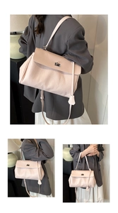 Detailed views of light pink lychee texture leather shoulder bag with silver twist lock