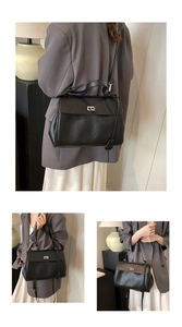 Detail of black pebbled leather handbag with silver twist lock and side charm tag