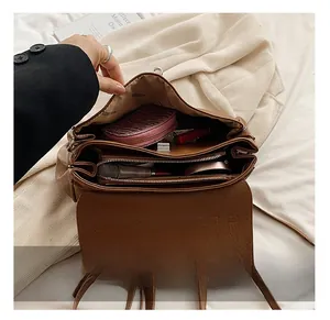 Detailed top view of brown leather bag interior with multiple spacious compartments