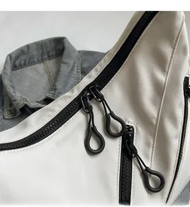 Close-up of matte waterproof white canvas bag with black zipper and soft rubber puller