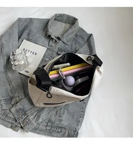 Spacious interior of beige nylon tote bag showing umbrella and books inside