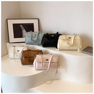 Litchi pattern leather shoulder bags in multiple colors with silver twist lock on display