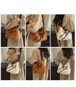 Detail view of the nylon tote bag showing side pockets and multi-zipper decorative design