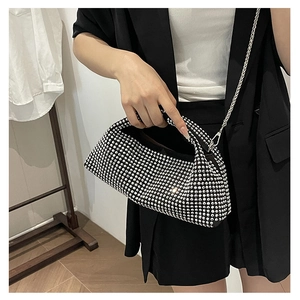 Silver rhinestone handbag with chain strap shown on model in stylish black blazer