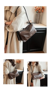 Detail view of large dark brown leather tote bag with silver zipper and metallic accent