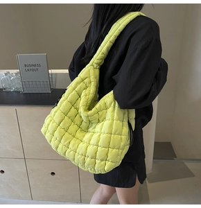 Macro shot of fluorescent quilted nylon tote with classic diamond stitching details