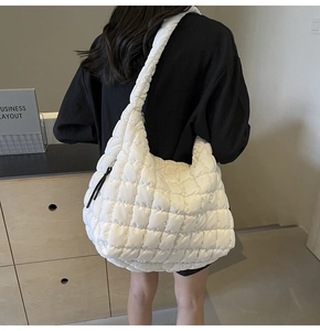 Back view of a woman wearing a white quilted bubble tote bag for a casual chic style