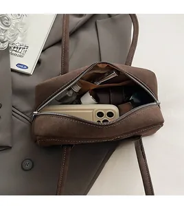 Top view of spacious interior in brown frosted shoulder bag with everyday essentials