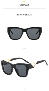 Detail of square black sunglasses featuring gold hollow triangle metal accents on temples