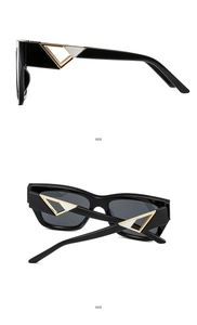 Detail view of square sunglasses with signature gold and silver triangle temple accents