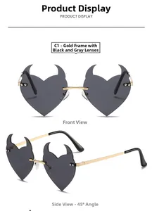 Detail of heart-shaped devil horn sunglasses with gold metal frame and dark grey lenses