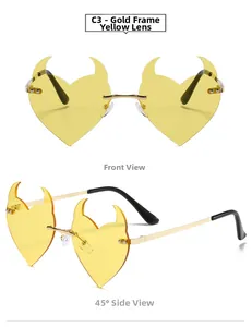 Detail view of heart-shaped devil horn sunglasses with gold frame and yellow lenses