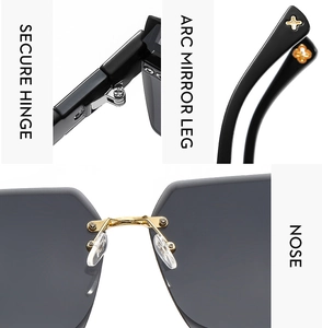 Detailed views of rimless sunglasses with gold hinges and clover logo on black temple tips