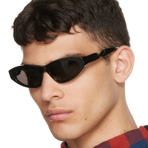 Close-up of black cat-eye sunglasses with twisted temples on male model side view
