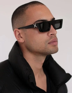 Detail shot of black rectangular sunglasses featuring distinctive white X on the temples