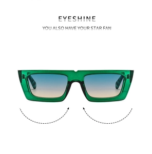 Detail of green square sunglasses frame with blue-yellow gradient lenses and star pattern