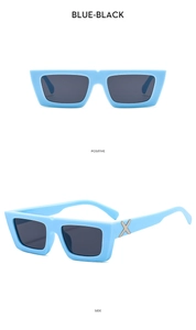 Detail of blue-black rectangular sunglasses with silver metal X logo on the temples