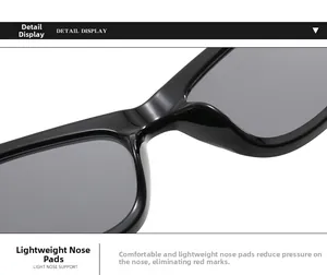 Macro detail of ergonomic thick integrated nose pads on glossy black sunglasses
